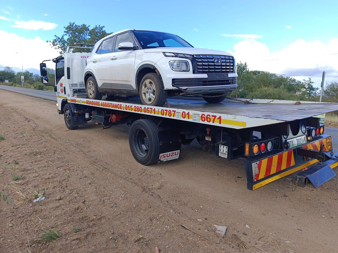 R81 technician changing tire for stranded motorist